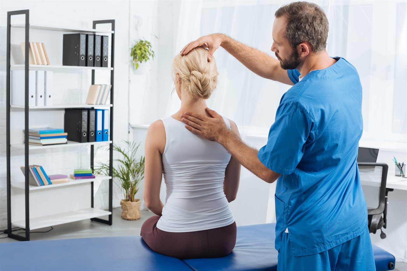 Chiropractor adjusting a patient's neck in Fort Myers