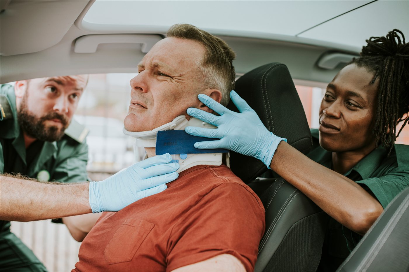 Paramedics fitting a neck brace to an auto accident patient in Fort Myers
